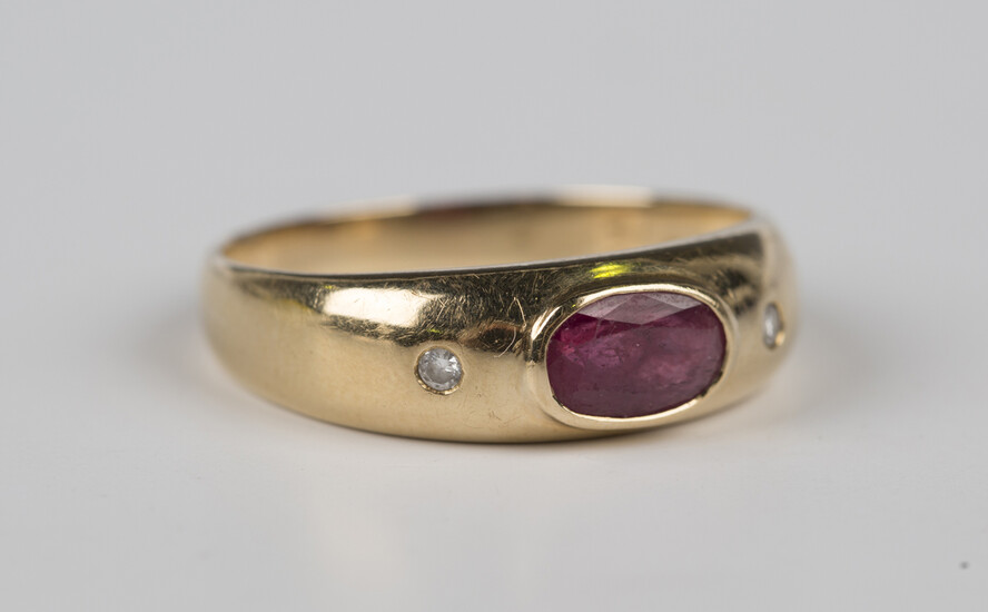 A gold, ruby and diamond ring, mounted with an oval cut ruby between diamond single stone sides, unm