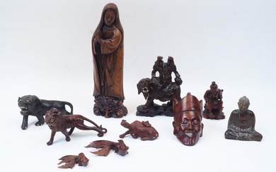 A group of ten Chinese wood carvings, early 20th century, comprising a figure of standing Madonna for the export market, 29.5cm high; a figure astride a lion, 13cm wide; a figure of a seated man, 10.5cm high; a seated Buddha, 10cm high; and a...