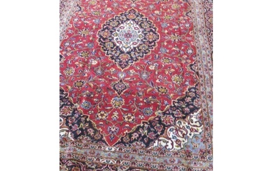 A hand knotted woollen Kashan rug - 3.56m x 2.37m