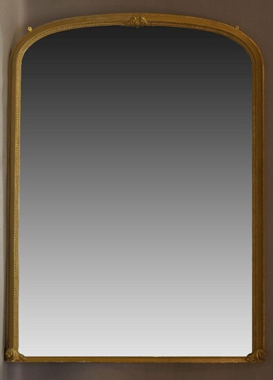 A large giltwood mirror, late 19th, early 20th Century, of arched form, the border with stiff leaf and carved acanthus decoration, 238cm x 174cm