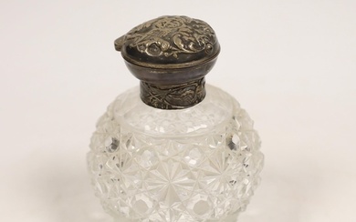 A late Victorian repousse silver mounted cut glass scent bot...