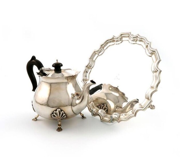 A late-Victorian silver teapot, by Charles Piling, London 1900, baluster form, wavy-edge border, on four hoof feet, plus a silver waiter, by the Barnards, London 1910, circular form, moulded border, on three scroll feet, diameter 21cm, approx. total...