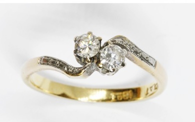 A mid 20th century two stone diamond cross over ring, total ...