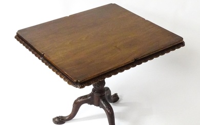 A mid / late 18thC mahogany tilt top table with an unusual m...
