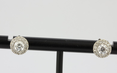 A pair of 18ct white gold halo stud earrings set with brilliant cut diamonds, approx. 1ct total, L. 0.8cm.