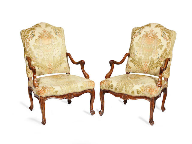 A pair of 18th century French provincial Louis XV solid walnut fauteuils
