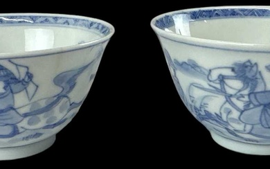 A pair of Chinese blue and white tea bowls decorated...