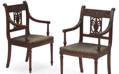 A pair of French 19th century mahogany Directoire armchairs, richly carved with...