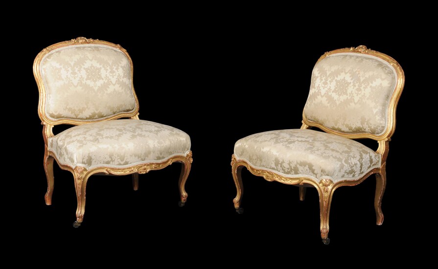 A pair of French carved giltwood low chairs in Louis XV style