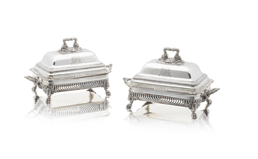 A pair of George III silver entrée dishes on Old Sheffield plate stands