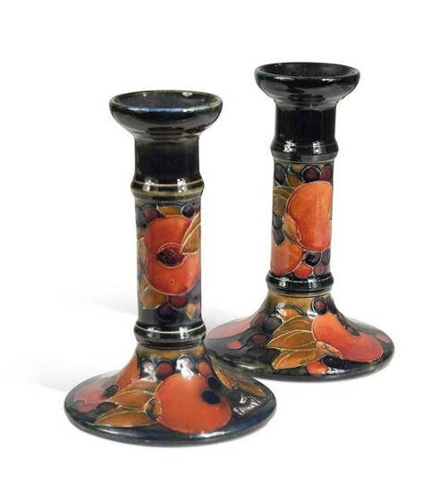 A pair of Moorcroft Pomegranate pattern candlesticks
