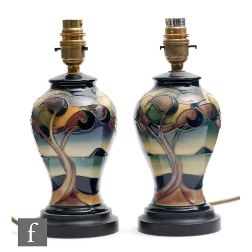 A pair of Moorcroft Pottery table lamp bases decorated in th...