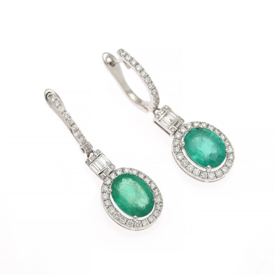 A pair of emerald and diamond ear pendants each set with an emerald weighing app. 3.25 ct. and diamonds weighing app. 0.85 ct., mounted in white gold.