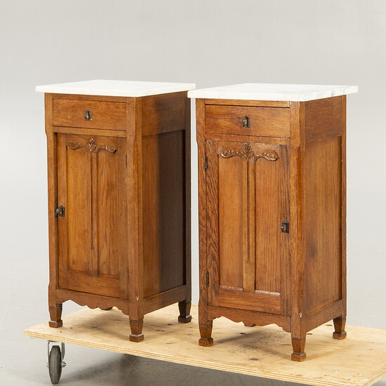 A pair of oak and marble bedside tables early 1900s