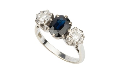 A sapphire and diamond three stone ring, the oval cut...