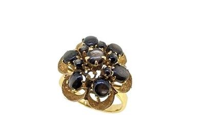 A star sapphire cluster ring, floral cluster set with round and oval cabochon black star sapphires