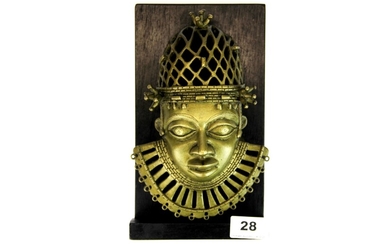 A wall mounted Benin bronze head, mount H. 24cm.