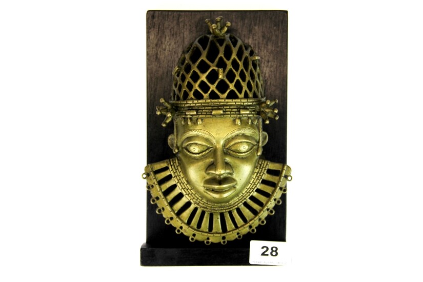 A wall mounted Benin bronze head, mount H. 24cm.
