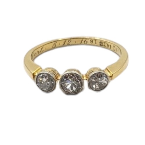 AN EARLY 20TH CENTURY 18CT GOLD AND DIAMOND THREE STONE RING...