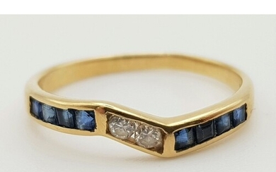 An 18K yellow gold ring with sapphires and diamonds. Ring si...