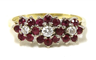 An 18ct gold diamond and ruby triple cluster ring