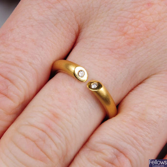 An 18ct gold open band ring, with diamond terminals.
