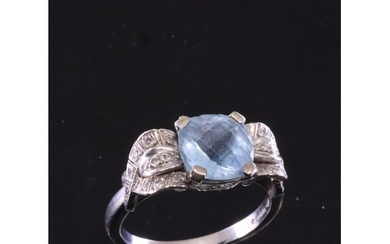 An aquamarine and diamond cluster ring set in 18ct gold fing...