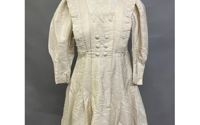 An early 20th century dress for a young girl, cream glazed c...
