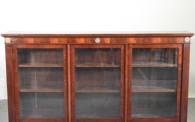 An early 20th century glazed mahogany dwarf bookcase, with gilt...