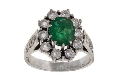 An emerald and diamond cluster ring, centring on an oval mixed-cut emerald framed by brilliant-cut diamonds, French assay mark, ring size M