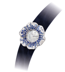 CHANEL. A LADY'S ATTRACTIVE 18K WHITE GOLD, SAPPHIRE AND DIAMOND-SET CAMELLIA-SHAPED WRISTWATCH WITH MOTHER-OF-PEARL DIAL, SIGNED CHANEL, CAMELLIA MODEL, CASE NO. D.H. 85888, CIRCA 2010