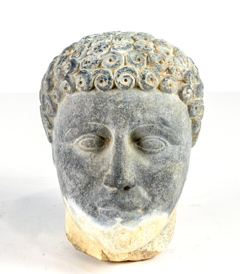 Carved stone head of a youth, after the antique