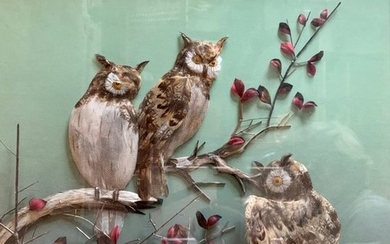 Diorama in feather representing three owls on a...
