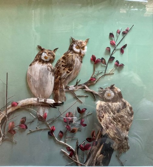 Diorama in feather representing three owls on a...