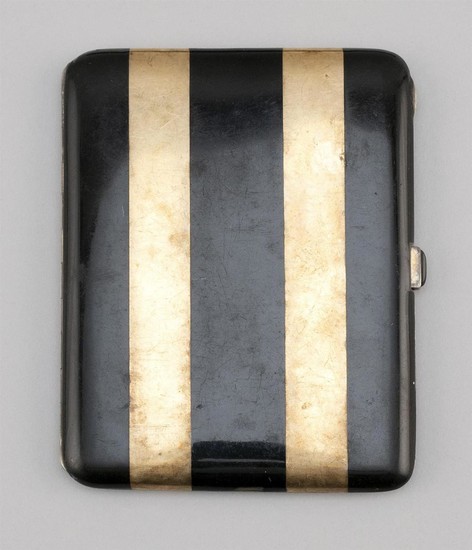 FRENCH GILT-SILVER AND ENAMEL CIGARETTE CASE Black enamel-striped exterior. Interior with engraved name, serial numbers and guarante...