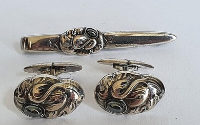 SOLD. Georg Jensen: A pair of cufflinks design. no 10, each set with a cabochon hematite, mounted in sterling silver, and a tie clip, design no. 201. – Bruun Rasmussen Auctioneers of Fine Art