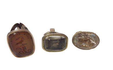 Georgian seal with intaglio carved carnelian depicting a family crest and motto 'Live in Hope', another with foiled-backed stone and 9ct gold mounted citrine seal (3)