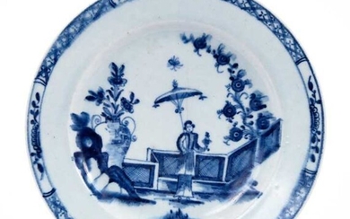 Lowestoft plate, painted in blue with a Chinese lady by a zig-zag fence and a large vase of flowers, with a diaper and half-flowerhead border, 22.3cm diameter
