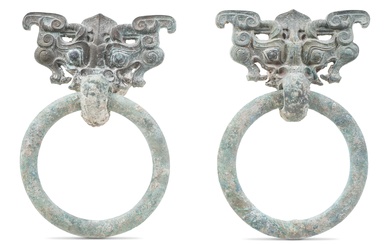 PAIR OF CHINESE BRONZE TAOTIE MASK AND RING HANDLES, WESTERN HAN DYNASTY Height of both: 7 1/2 in. (19.1 cm.)