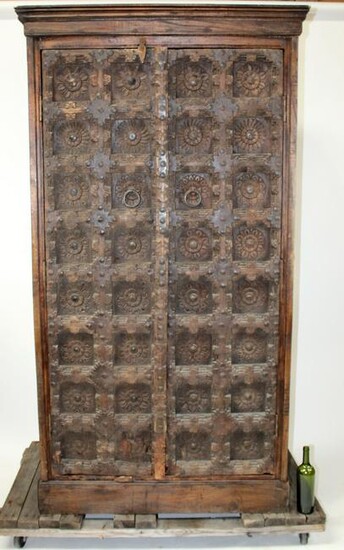 Relief carved Iron studded armoire