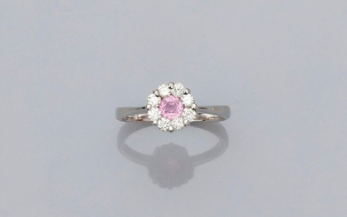 Round white gold ring, 750 MM, centered with a pink sapphire in a row of brilliants, size: 55, weight: 2.8gr. gross.