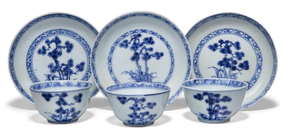 Three pairs of Chinese porcelain blue and white 'pine' teabowls and saucers excavated from the Nanking Cargo, circa 1750, painted with pine trees amongst rockwork, 6.2cm-10cm diameter (6) Provenance: with Christie's Nanking Cargo paper labels to...