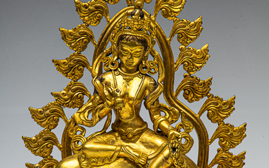 Tibetan three part gilt figure of Marici seated on a...