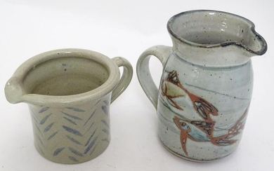 Two studio pottery jugs, one with stylised fish