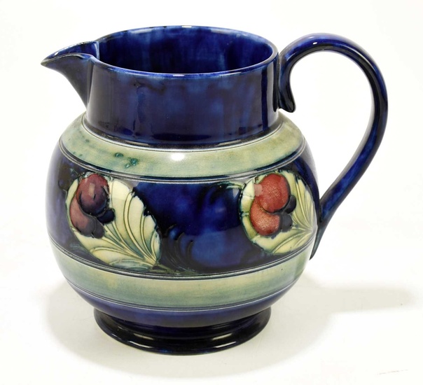 WILLIAM MOORCROFT; a bulbous jug decorated in the 'Wisteria' pattern...