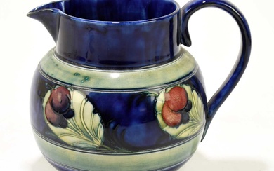 WILLIAM MOORCROFT; a bulbous jug decorated in the 'Wisteria' pattern...