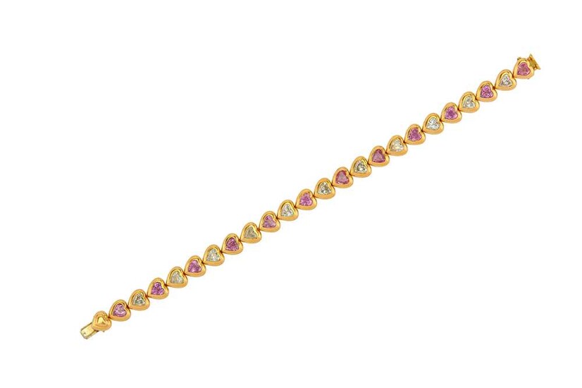A diamond and pink sapphire line bracelet The line...