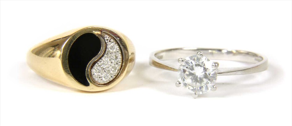 A gold diamond and enamel yin and yang ring