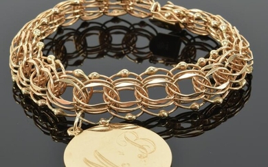 14K gold overlapping link bracelet, suspending a charm