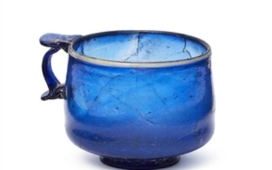 A Roman cobalt blue glass cup, 1st...